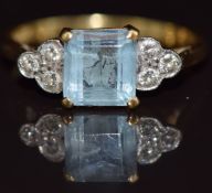 An 18ct gold ring set with an emerald cut aquamarine of approximately 1.3ct and diamonds, 3.2g, size