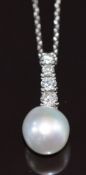 A 14k white gold pendant set with a pearl and four graduated diamonds, the largest approximately 0.