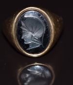 A 9ct gold ring set with a hematite intaglio, 7.4g, size R