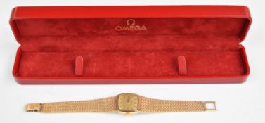 Omega De Ville 9ct gold ladies wristwatch with black hands and baton hour markers, gold dial and