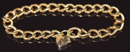 A 9ct gold curb link bracelet with heart padlock clasp, 6.8g