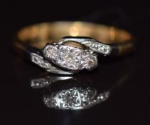 An 18ct gold ring set with three diamonds in a platinum twist setting, 2.2g, size K