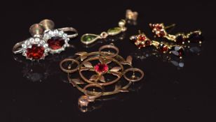 Two pairs of yellow metal earrings set with garnets, a 9ct gold pendant and a single peridot earring