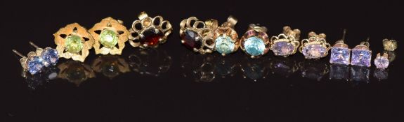 Seven pairs of 9ct gold earrings including garnet, peridot, zircon, paste, etc, 9.7g