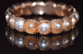 A c1900 9ct rose gold eternity ring set with split pearls, 2.2g, size L