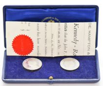 Cased pair of Kennedy commemorative limited edition 32mm palladium coins, by Slade, Hampton & Son