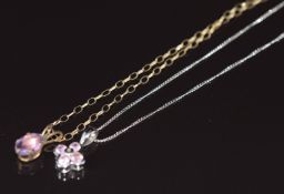 A 9ct white gold pendant set with a diamond and pink sapphires, on 9ct white gold chain together