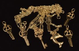 Seven 9ct gold pendants including six 18 & 21 keys and a dolphin and seven 9ct gold chains, 7.4g