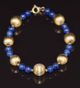 A bracelet made up of textured gold beads and blue beads, 12.6g 20cm