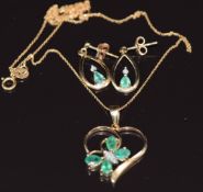 A 9ct gold pendant set with emeralds and diamonds in the form of a butterfly, with similar earrings,