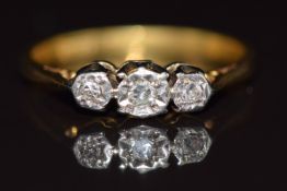 An 18ct gold ring set with three diamonds in a platinum setting, 2.2g, size L