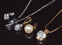 A 9ct white gold pendant set with a diamond on 9ct white gold chain, 9ct gold pendant set with cubic