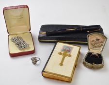 An 18ct gold ring set with three diamonds in a platinum setting, paste brooch, pen, bible, silver