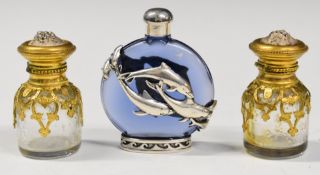 Three metal mounted scent bottles comprising a pair with engraved gilt mounts and embossed tops