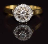 An 18ct gold ring set with diamonds in a cluster, 4.1g, size M