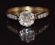 An 18ct gold ring set with an old cut diamond of approximately 0.9ct, with diamond encrusted