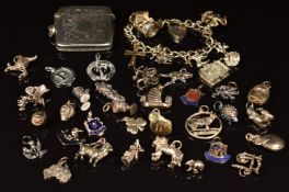 A silver charm bracelet with 25 silver charms and a hallmarked silver vesta