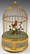 Automaton clockwork singing bird in cage, marked to base Western Germany, height 24cm