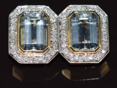 A pair of 18ct gold earrings each set with an emerald cut aquamarine of approximately 7.3ct
