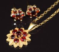 A 9ct gold pendant set with garnets, with similar earrings, 4.3g