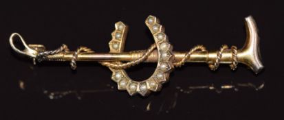 A yellow metal brooch set with seed pearls in the form of a riding crop and horseshoe 4.1g 5.5x1.