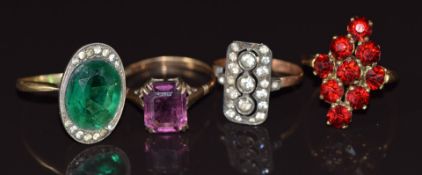 Four 9ct gold rings set with paste in silver/ metal settings