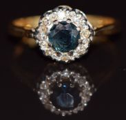 An 18ct gold ring set with a sapphire surrounded by diamonds, 2.9g, size J