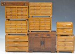 A collection of Art Deco style miniature / apprentice chests of drawers including haberdashery style