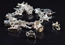Silver charm bracelet with fifteen silver charms including horseshoe, frog, tiger, church, etc