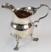 Georgian hallmarked silver milk jug raised on three feet, London 1757, maker's mark rubbed but