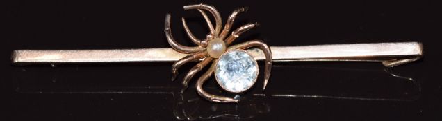 A 9ct gold bar brooch in the form of a spider set with a round cut aquamarine and pearl, in Mikara