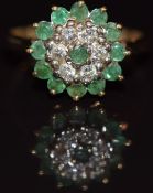 A 9ct gold ring set with diamonds and emeralds in a cluster, 3.6g, size O
