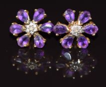 A pair of 9ct gold earrings set with amethysts and diamonds in a floral cluster, 3.4g 1.8cm