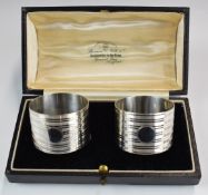 Cased pair of Art Deco hallmarked silver napkin rings, Birmingham 1926, maker Docker & Burn Ltd, the
