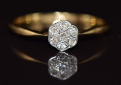 An 18ct gold ring set with diamonds in a platinum setting, 1.6g, size L