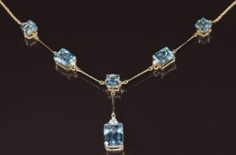 A 9ct gold necklace set with emerald cut topaz and diamonds, 13.8g