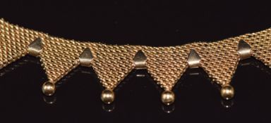 An 18ct gold collarette necklace, the 35 triangular sections each with spherical decoration,