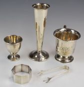 Hallmarked silver items comprising vase, christening mug, sugar nips and egg cup, together with an