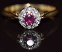 An 18ct gold ring set with a ruby surrounded by diamonds, 3.1g, size P