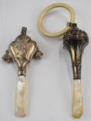 Two hallmarked silver coral handled baby's rattles, Birmingham 1927 the other Birmingham 1923,