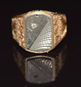 An 18ct gold signet ring with embossed shoulders and silver plaque to the centre, 9.8g, size S