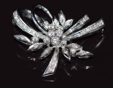 An 18k white gold brooch set with diamonds in a stylised floral design, total diamond weight