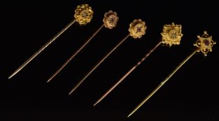 Four 9ct gold stick pins, one set with a diamond, two with a ruby (3.7g), and the other a 15ct