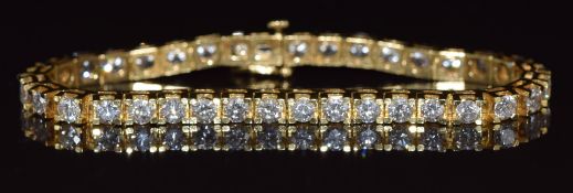 An 18ct gold tennis / line bracelet set with 36 round brilliant cut diamonds, each approximately 0.