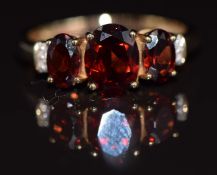 A 9ct gold ring set with garnets and diamonds, 2.8g, size P
