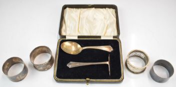 Cased hallmarked silver spoon and pusher set, two hallmarked silver napkin rings and two silver