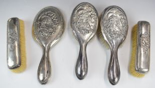 Edward VII hallmarked silver dressing table set comprising hand mirror and two pairs of brushes, all