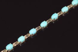 A 9ct gold bracelet set with turquoise cabochons and Greek key links, 6.5g 18cm