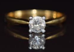 An 18ct gold ring set with a round brilliant cut diamond of approximately 0.74ct, with