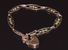 A 9ct rose gold bracelet made up of pierced links with heart padlock clasp, 10.3g 20cm